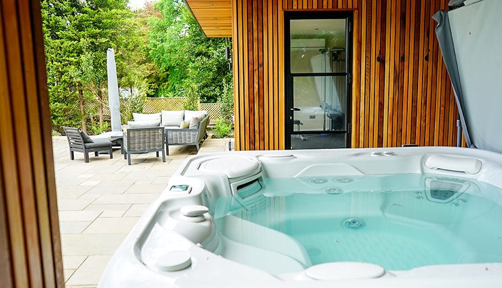 Bespoke cedar garden room with corner glazing and decked terrace — Surrey