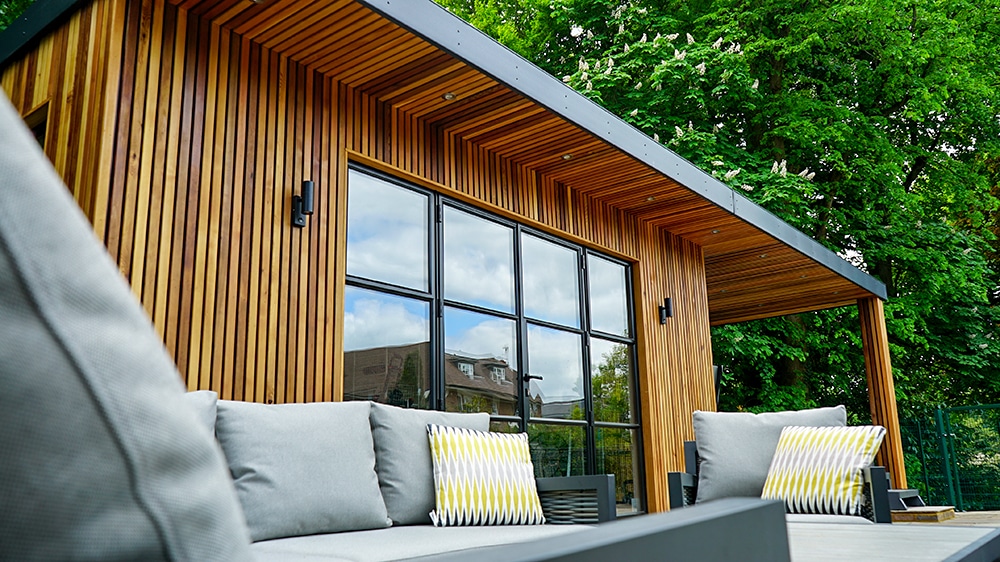 Bespoke cedar garden gym and pool house with canopy and crittal-style doors