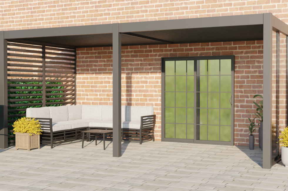 Frontal view of a 6m x 3m wall-mounted Romanso Luxury Aluminium Pergola with an anthracite grey finish, captured on a sunny day. The pergola features integrated LED lighting, optional electric blinds, and adjustable louvres, all controllable by a remote. It is elegantly situated on a patio, outside the back doors with a comfy seating set-up.