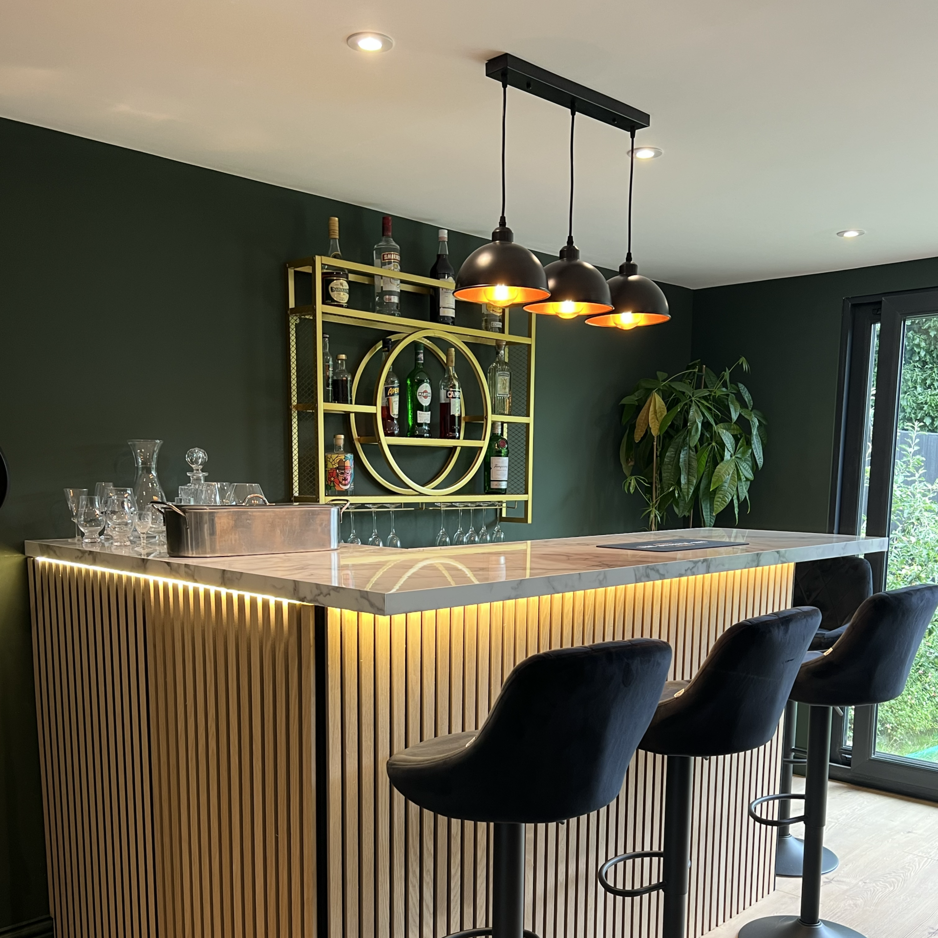 Garden room set up as a gaming den with multiple screens and console setup in Surrey