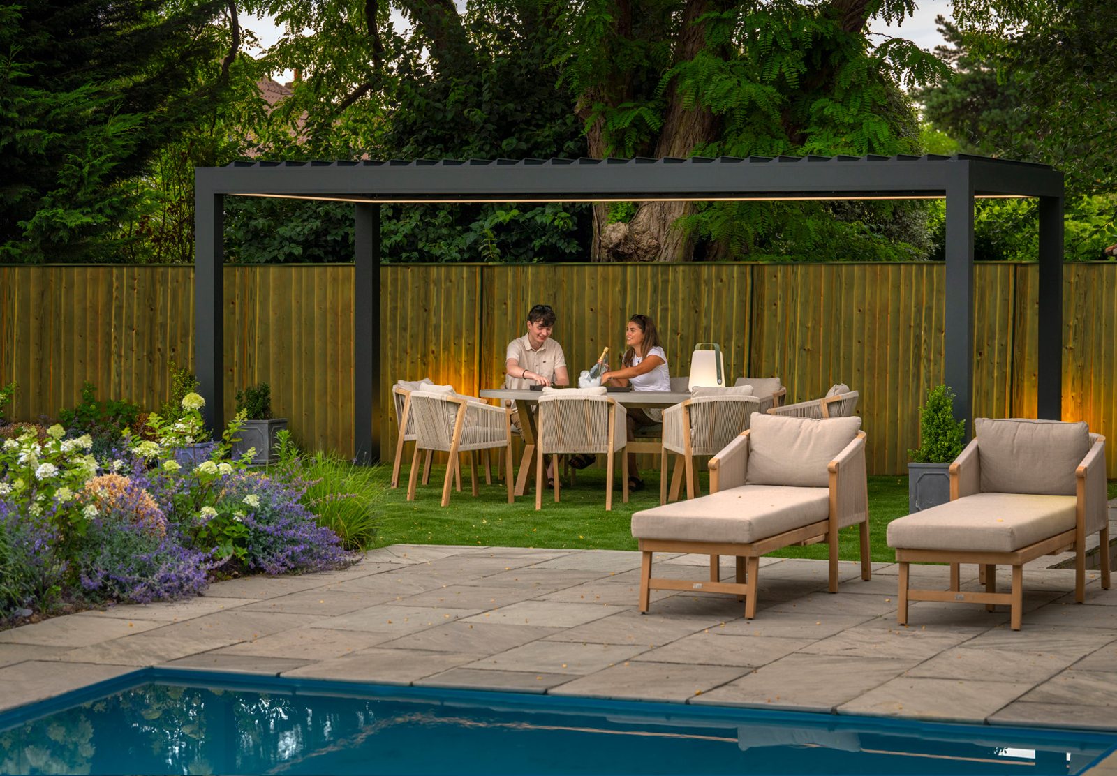 Anthracite Morvelle bespoke pergola over a poolside patio