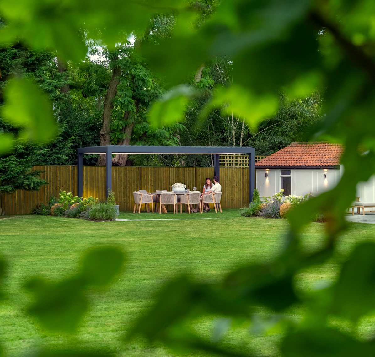 Bespoke louvred pergola at the end of a long garden