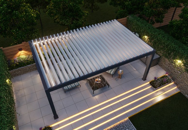 Bespoke bioclimatic pergola from above with louvres open and LED lighting at dusk