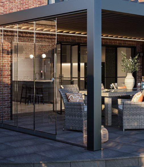 Sliding glass doors enclosing a bespoke louvred pergola by a house