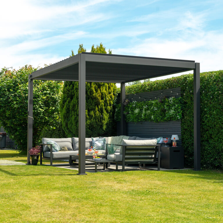 3m x 3m grey aluminium louvred pergola in a garden with outdoor seating